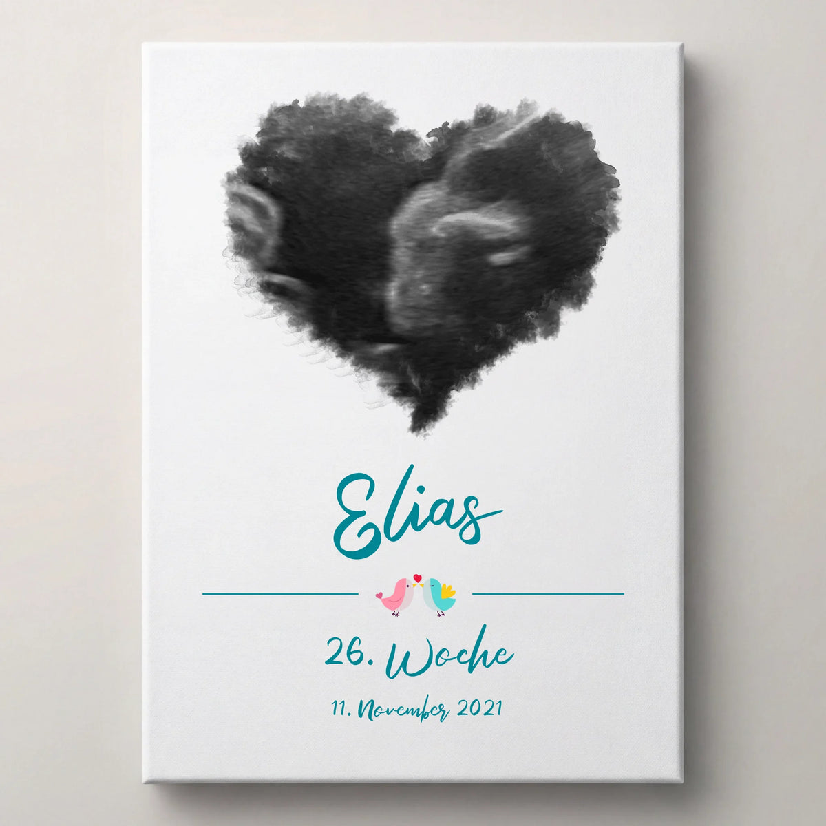 Personalisierte Erinnerungsbilder als weiße Leinwand mit schwarzem Herz aus zwei Profilen, dem Namen Elias und Datum